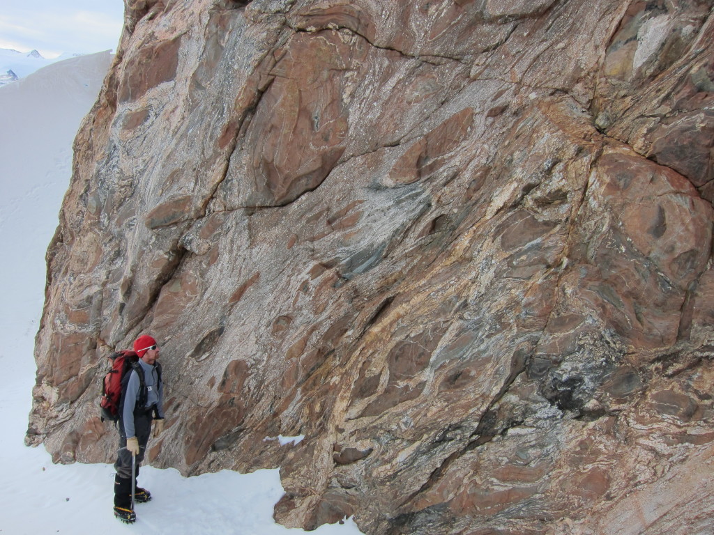 Figure 12. My supervisor, John Cottle, examines a shear zone with ellipsoidal and sigmoidal pods of paragneiss in a migmatitic matrix.