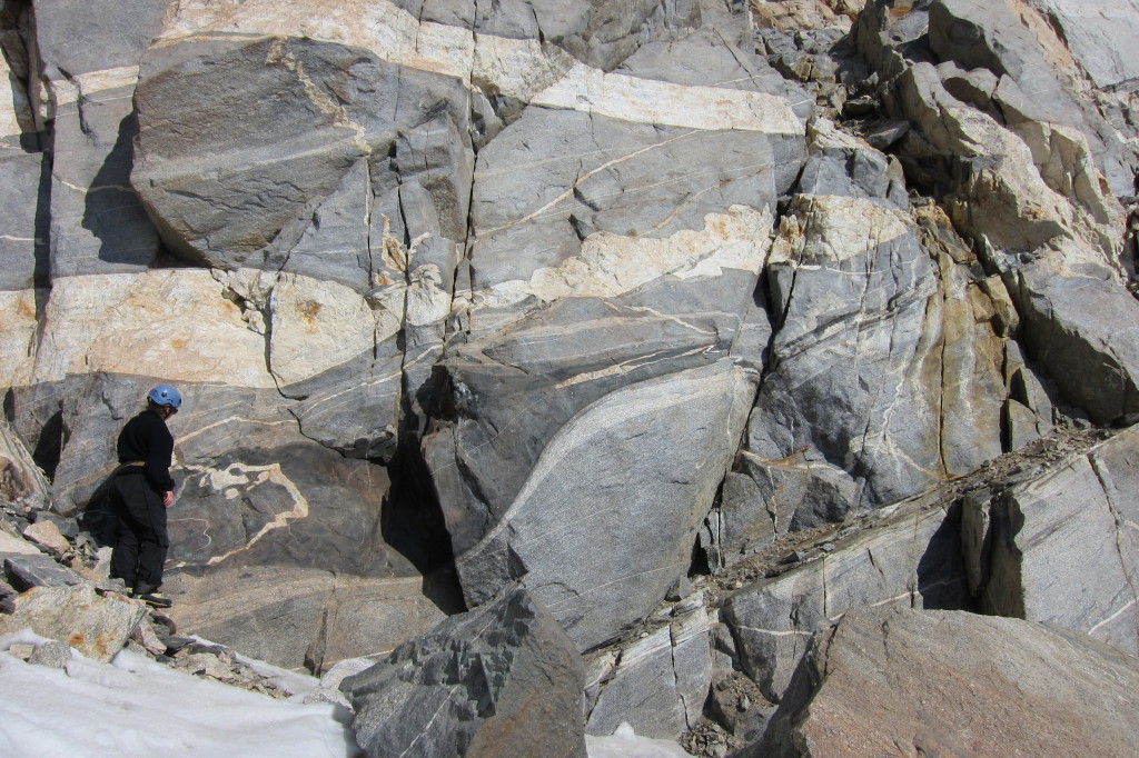 Figure 14. My friend and lab mate, Sophie Briggs, examines a pod of diorite that is enveloped in strained grey orthogneiss.