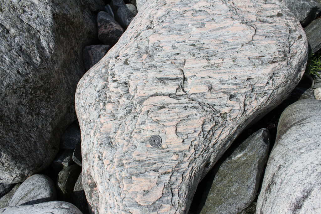Lineated gneiss boulder, indicating constrictional strain