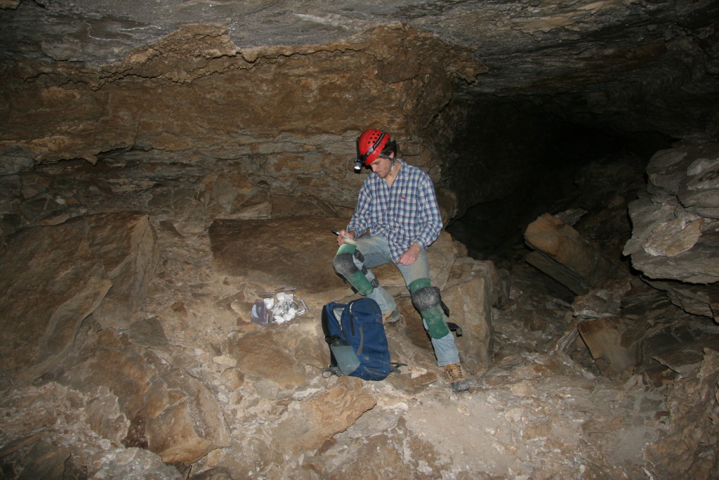 The author labeling gypsum samples.  Due to the delicate nature of the samples, they needed to be individually wrapped in tissue paper.   At this location, the surface of the gypsum was stained red.
