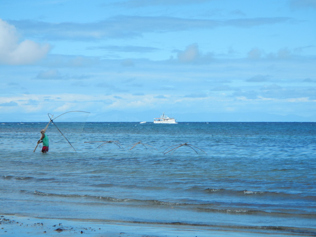 Figure 12. Arrival of the Sara Lee with a local fisherman maneuvering his nets. 