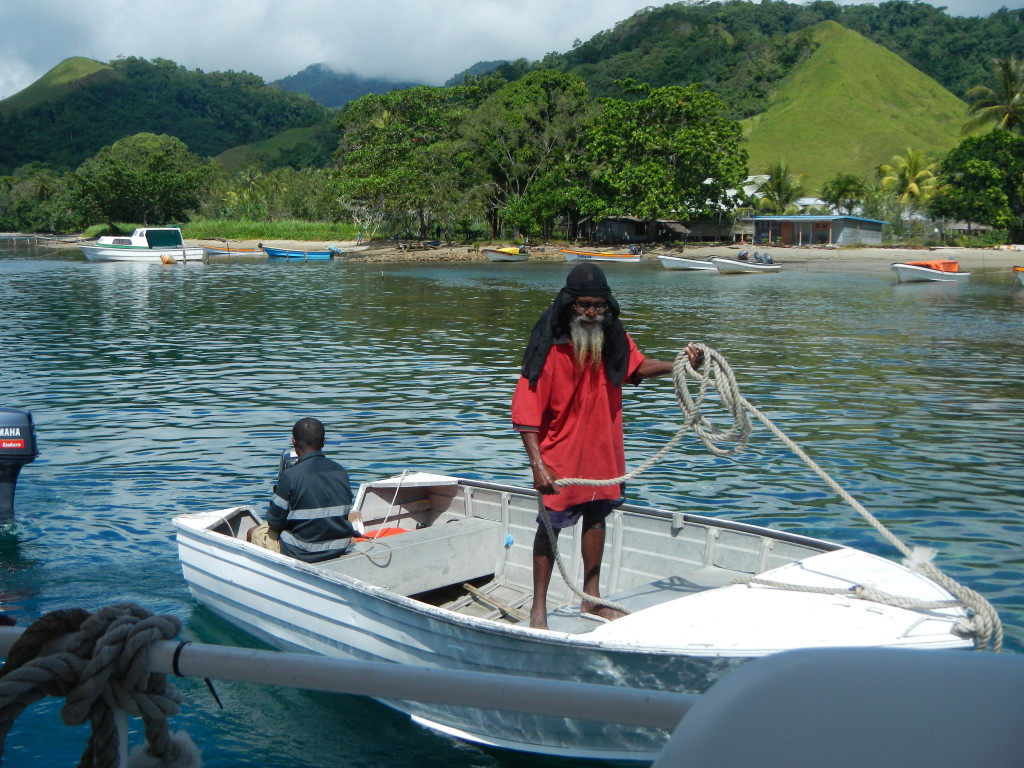 Figure 4. Captain Sam and Mark moving the dinghy, Esa’ala, Normanby Island. 