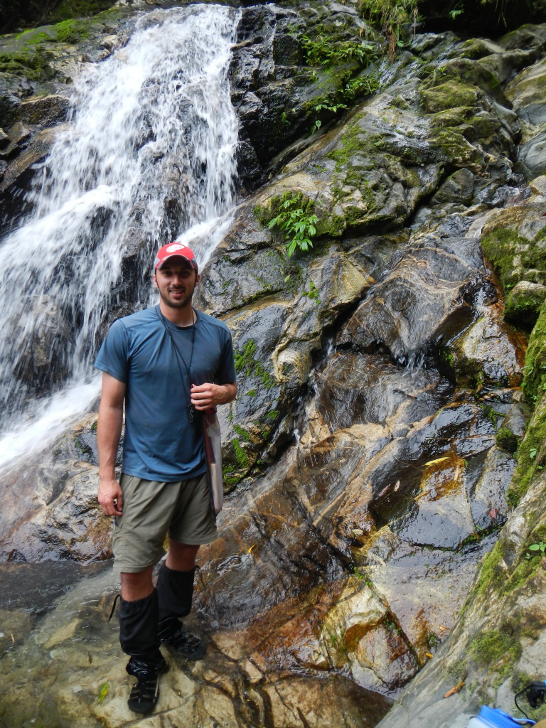 Figure 6. Myself posing near one of the many waterfalls we encountered, Fakwaoia River, Goodenough Island.