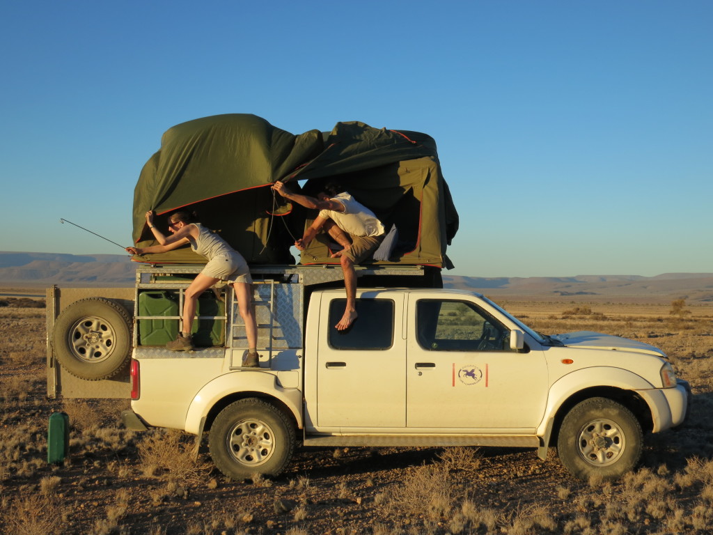 An evening’s entertainment pitching tents on top of our field vehicles. Picture by Rachel Wood. 