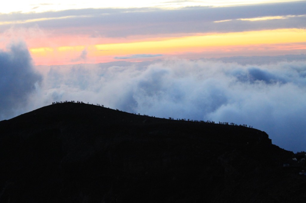 Fig. 5 - Sunrise at the summit of Mt Fuji, with tourists lining the caldera rim.