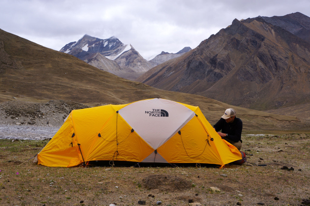 Andrew Laskowski preparing for a field traverse in the Lopu Range during a backpacking in summer, 2012. Photo by Devon Orme.