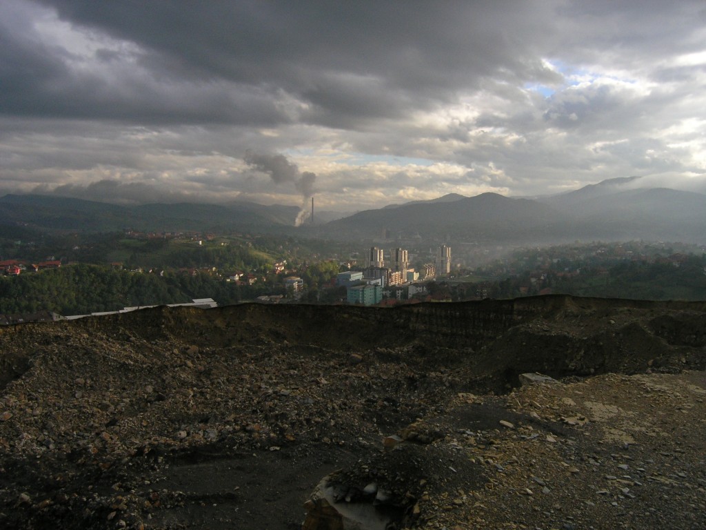 Surreal view on a cement quarry with the factory in the back.