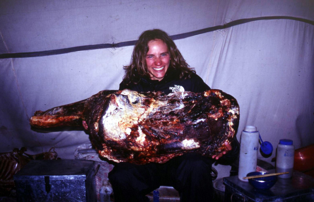 Me, inside of our cook tent, holding a side of yak. Our drivers carried this thing around in the Dong Feng for two months, peeling pieces of yak jerky off of it for snacking, or adding to our evening meals.