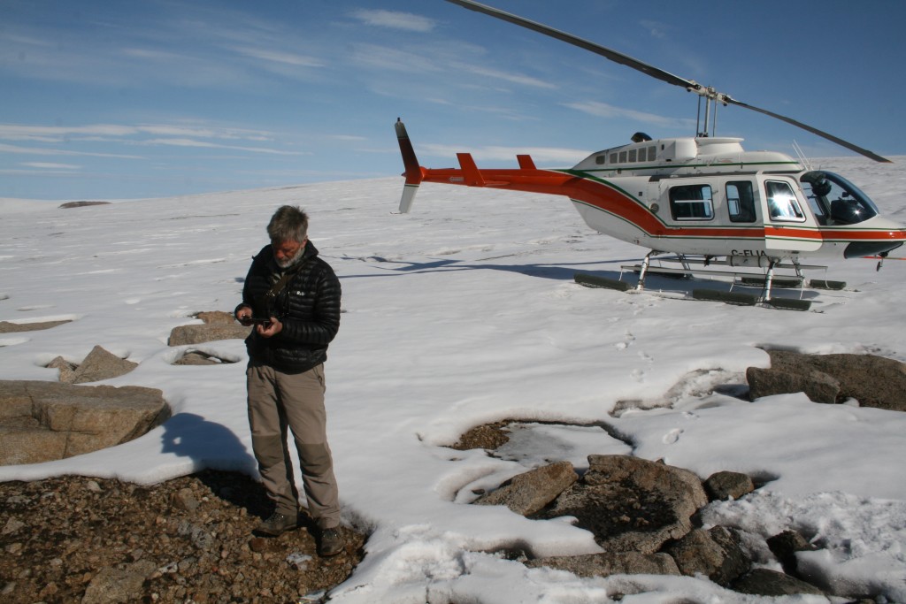 Dr. Gifford Miller making the long trek from the helicopter to the ice edge sampling dead moss emerging from the retreating ice edge.