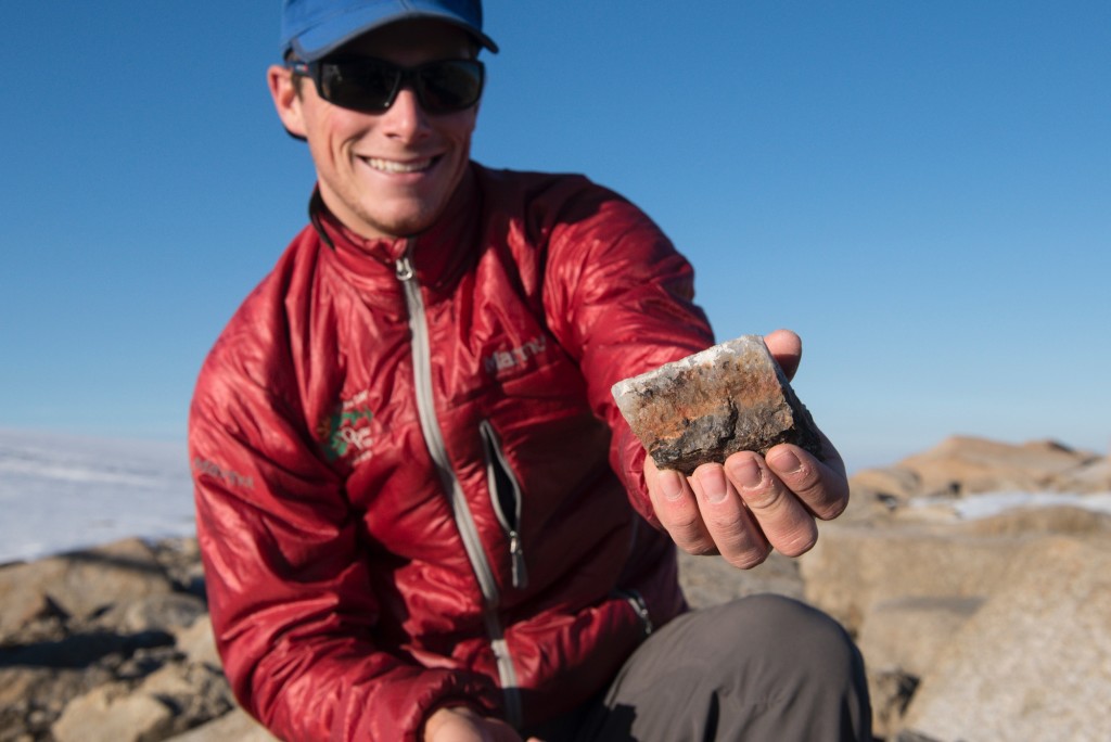 The author with a sampled piece of pure quartz from exposed bedrock, which he hopes contains all the answers to his PhD. 