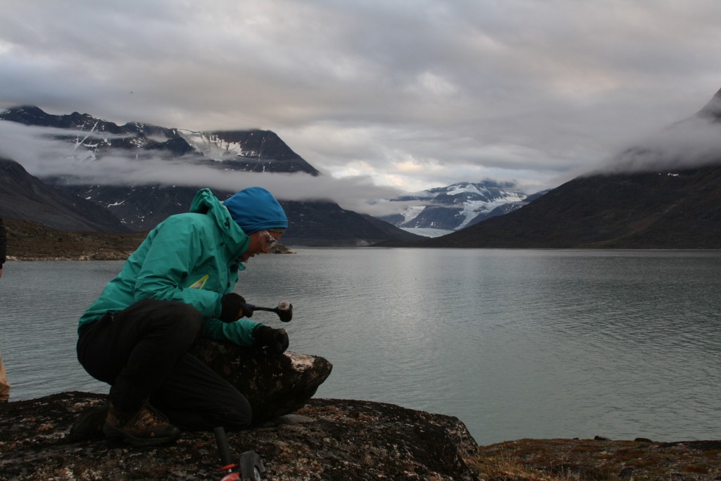 Sarah Crump tackling her latest rock sample the old fashioned way; hammer and chisel.