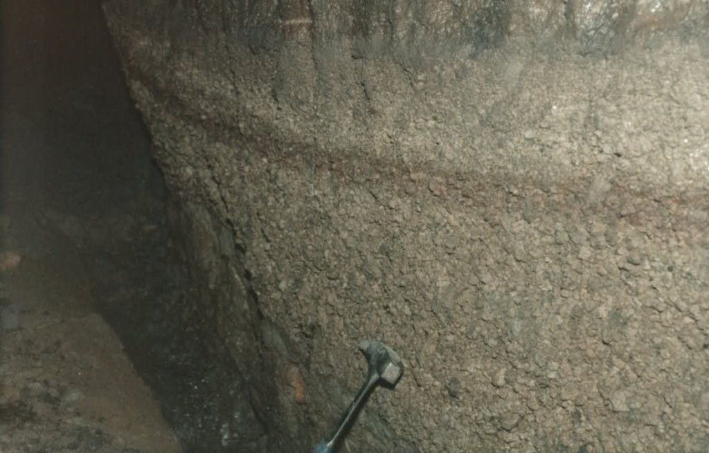 Campanian Ignimbrite basal lapilli fall deposit in a deep cave 53 km from the source. This part of the cave was just 0.5m large and 1.5 m height with a trickle of water on the floor. The photo is undersaturated because lit only by the camera flash.