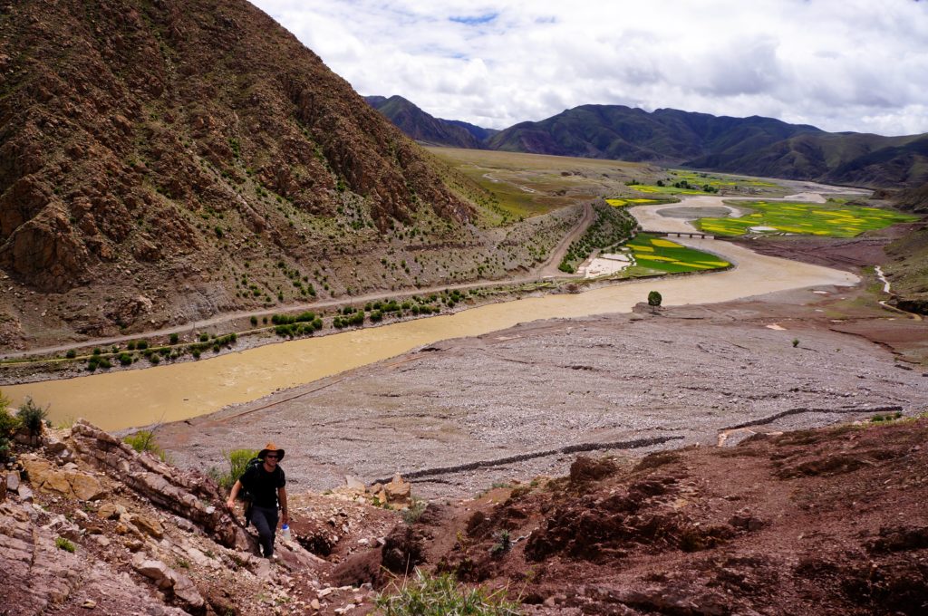 Graduate student Simon Stickroth approaching a section of conglomerates north of Ngamring