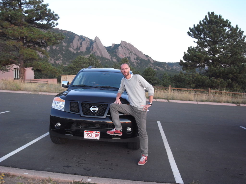 Me in front of SUV and more importantly; the Flatirons!