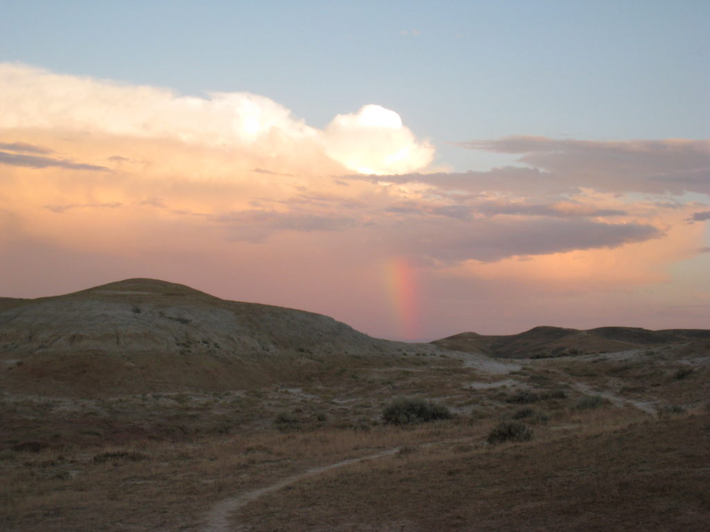 Rainbow over road leading out of camp.