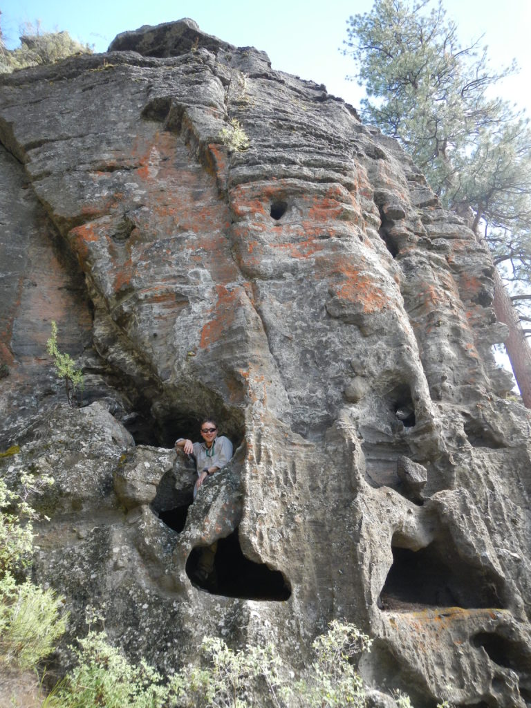 Matthew Nikitczuk standing inside a cavity within a layered tuff deposit of Hole-in-the-Ground maar. Photo by Frank Popoli.