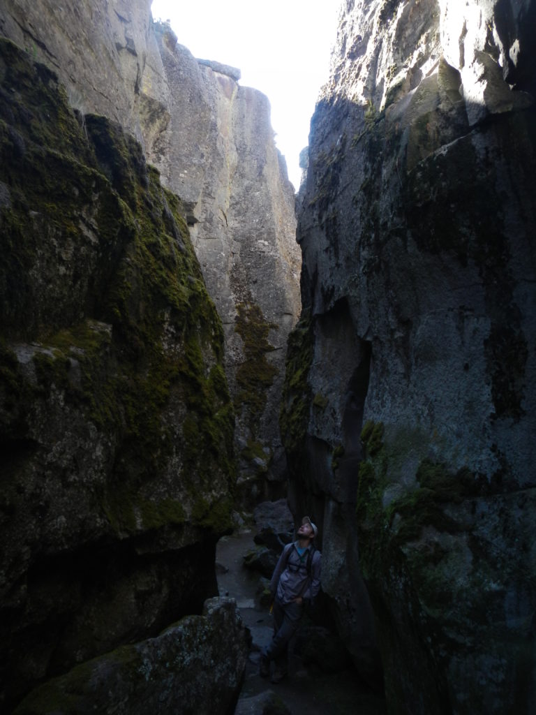 Matthew Nikitczuk standing inside a large open fracture (Crack-in-the-Ground) within a lava flow. Photo by Nevena Novakovic.