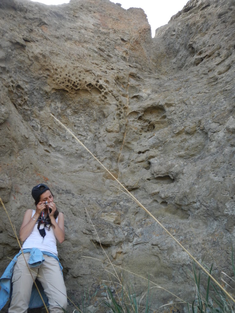 Nevena Novakovic examining a portion of tuff in the Black Hills up close with her hand lens. Photo by Matthew Nikitczuk.