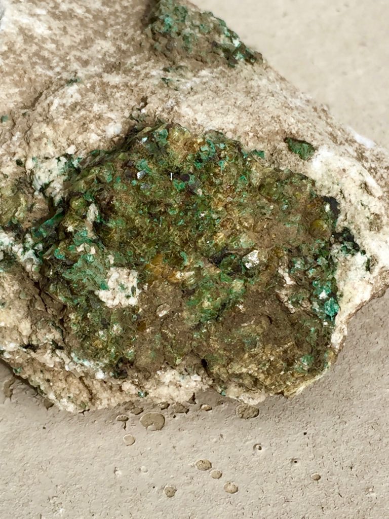 Diopside crystal faces in a carbonate rock.