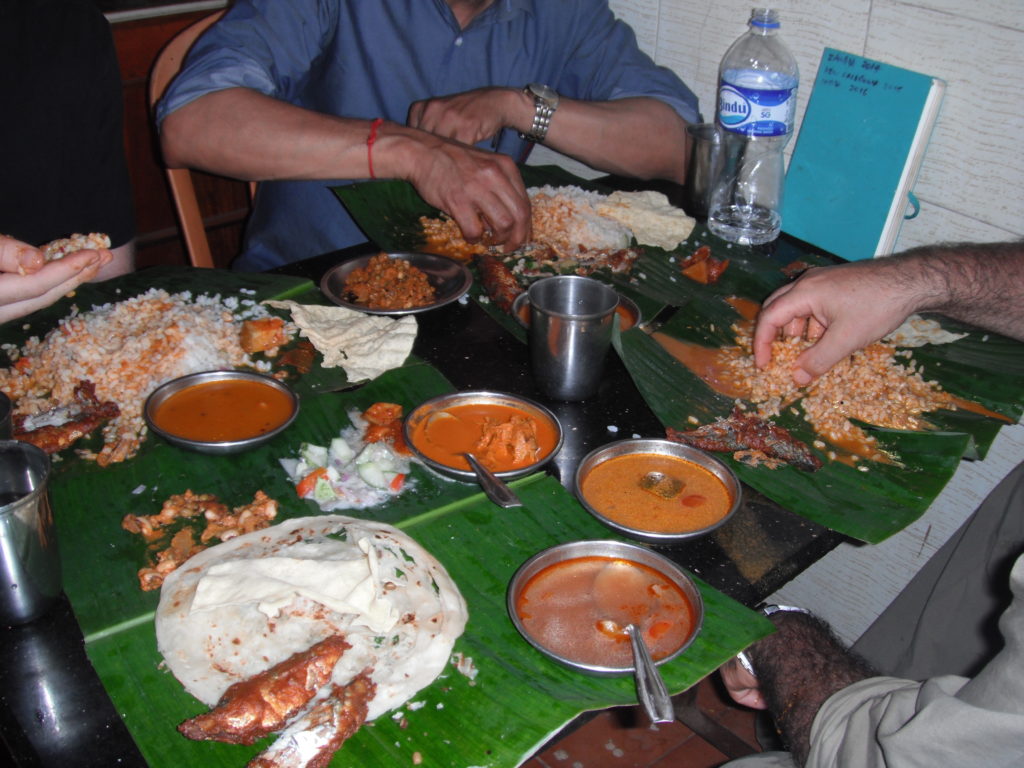 A typical serving of Indian food consisting of several curries, a tonne of rice, naan and fish – all served on a banana leaf.