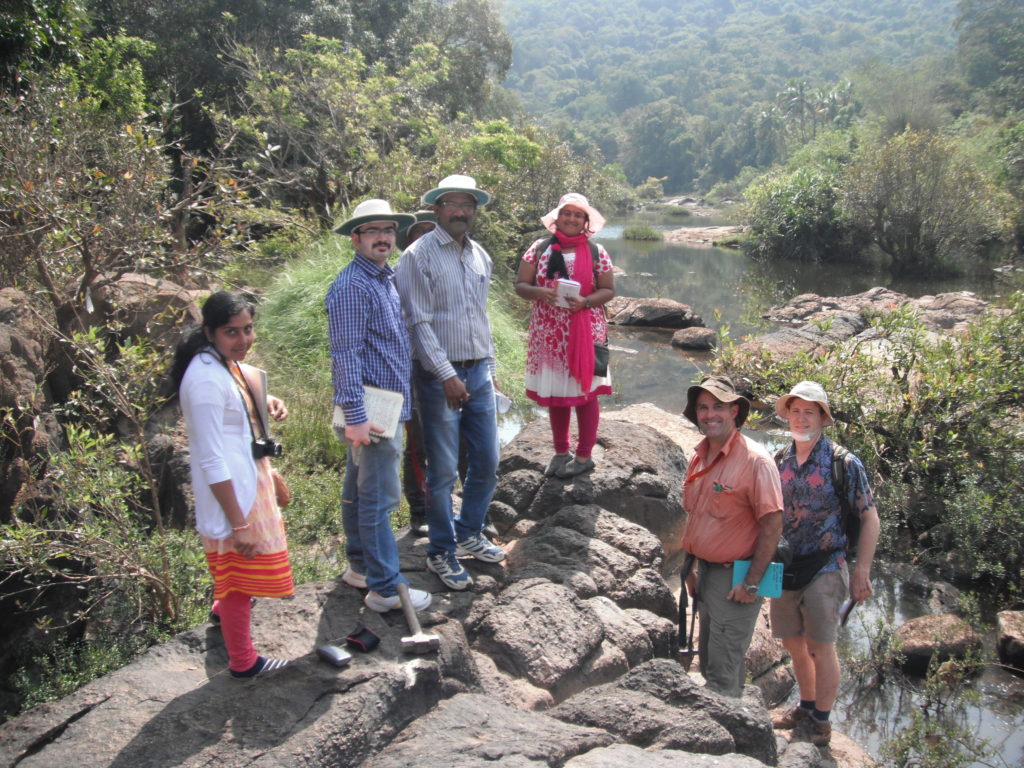 The field team looking at an outcrop in a river bed.