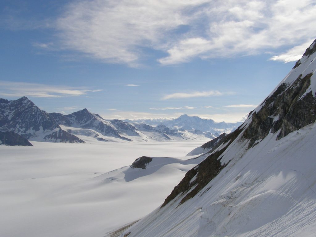 Hubbard Icefield with only the highest peaks towering above the ice.