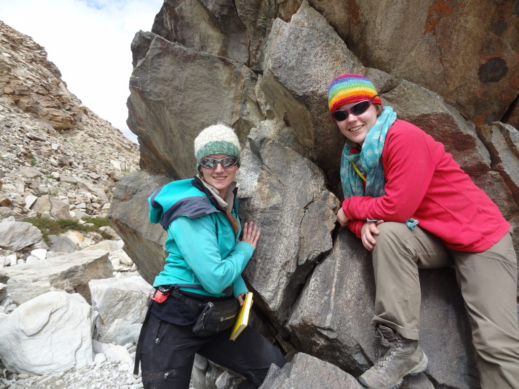 Anna and Eloise (field assistant) looking at a garnet-bearing eclogite boulder