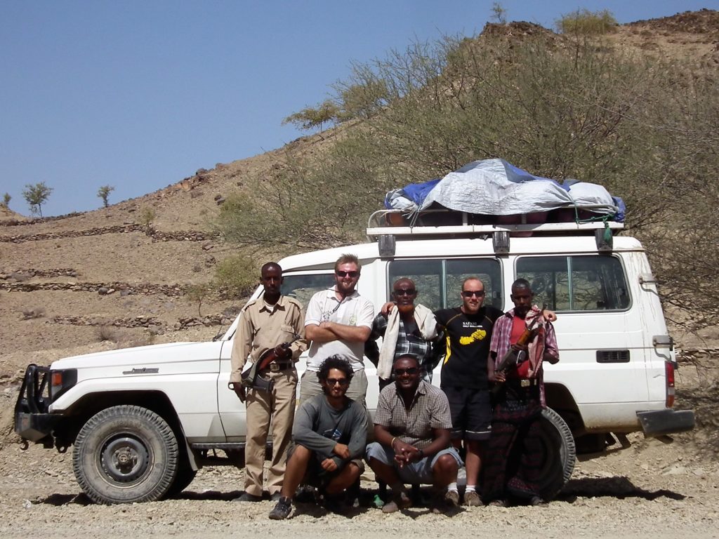 Us three posing in front of the Landcruiser with our translating-driver, Jomo, our guide, Red-Beard and our two armed chaperones.